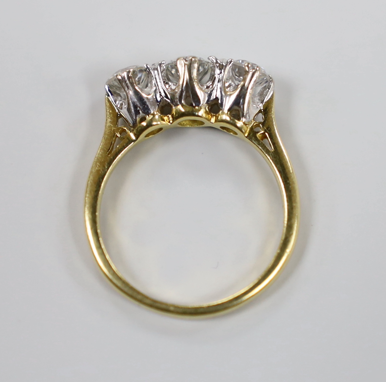 A 1970's 18ct gold and three stone diamond set ring, size O/P, gross weight 4.7 grams